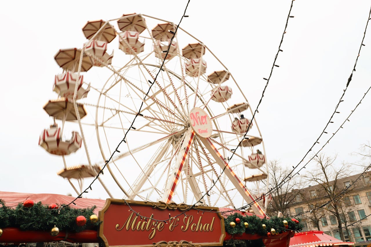 Enjoy the festive vibe at Kassel Christmas Market with a large ferris wheel and string lights.